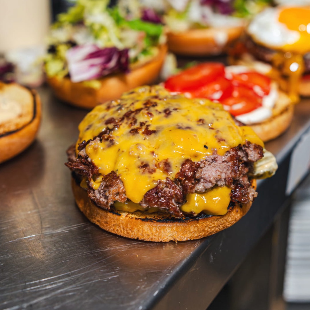 Smash beef being prepared on the grill at PAMPA Smash Burger